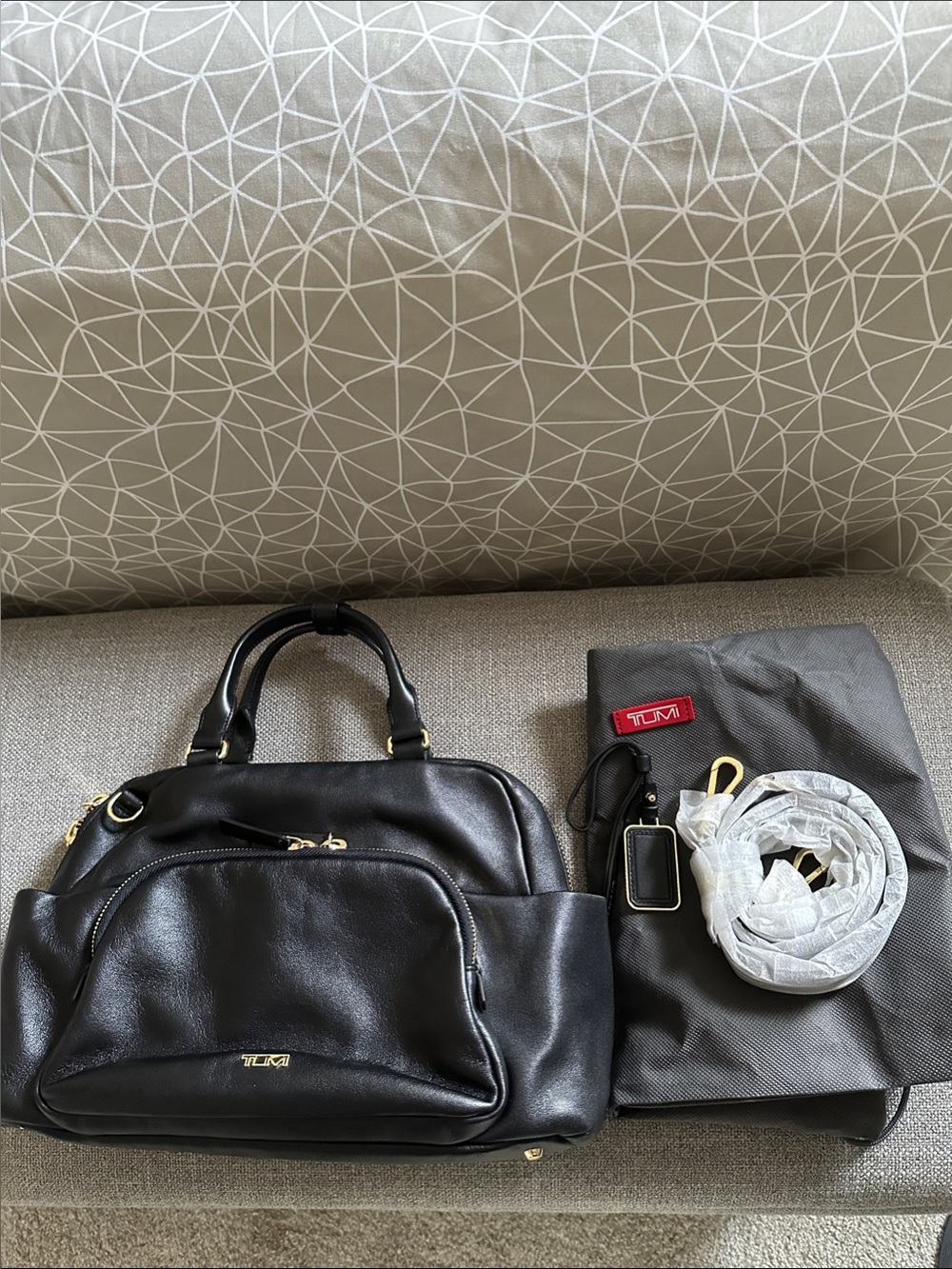 Tumi Leather Adrian Voyageur with Gold Hardware